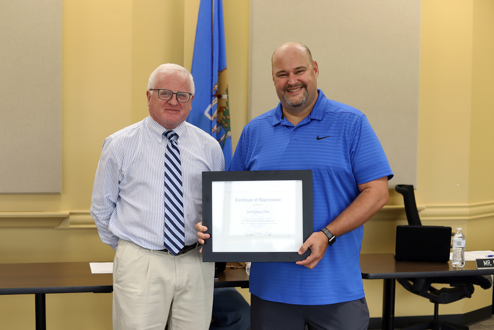 Board of Education President Mike Mullins Presents Sand Springs Home with Certificate of Appreciation