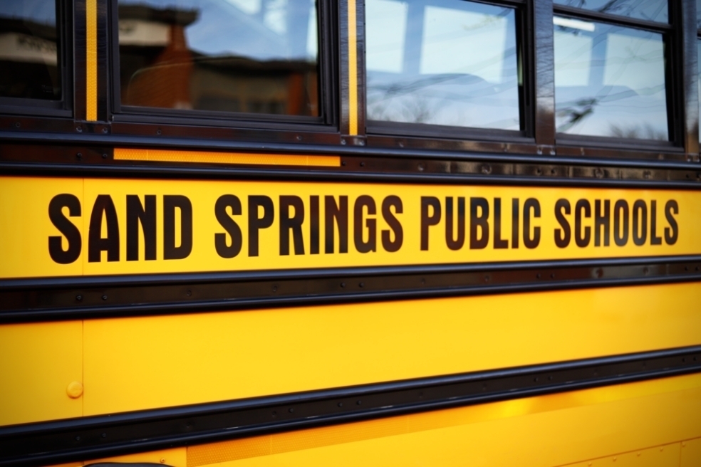 Side of School Bus text reading Sand Springs Public Schools